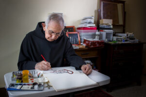 Fr. Vincent Trujillo, OSB, writes calligraphy.