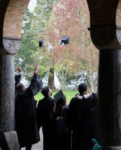 2021 graduates at Mount Angel Seminary toss their hats.