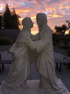 Visitation Statue at sunrise, October 2022, between bands of showers