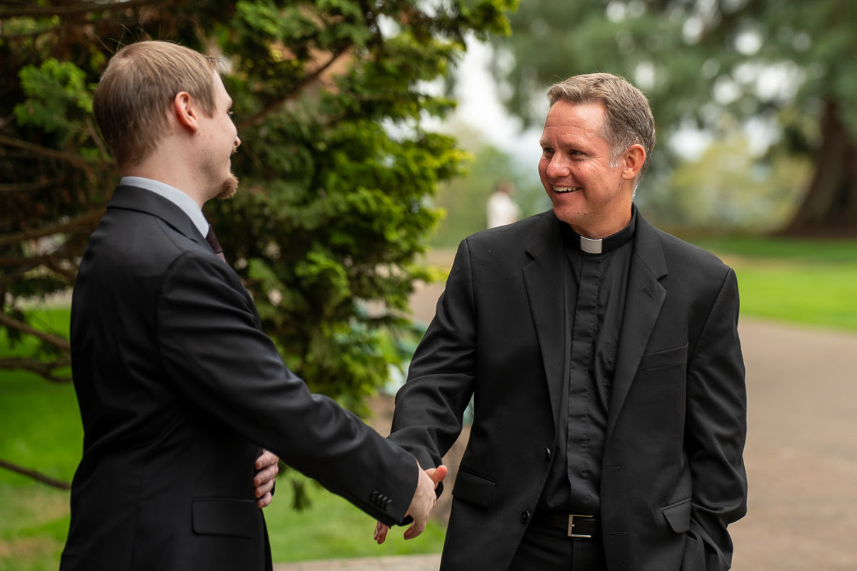Fr. Jeff Eirvin shaking hands with seminarian David Jablonski