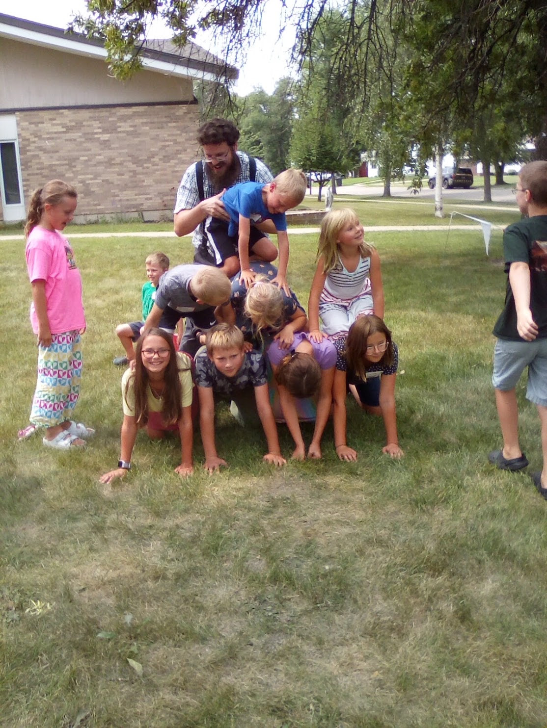Human pyramid with oblate kids