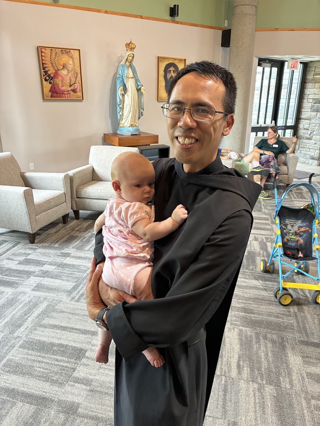 Fr. John Paul with baby