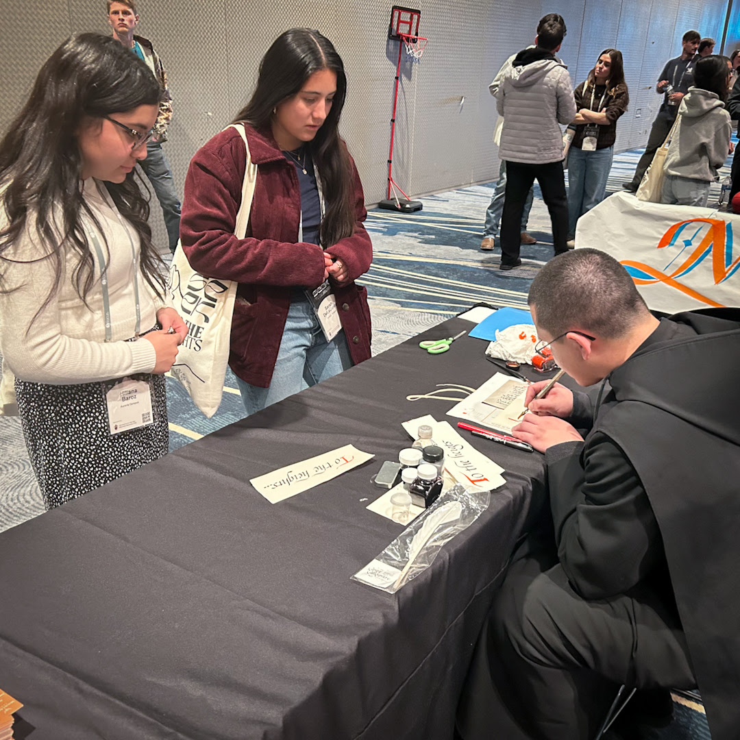 Br. Isaiah doing calligraphy at SEEK26